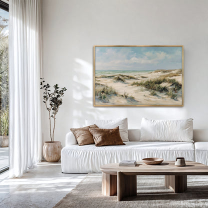 Large coastal dunes framed wall art hanging above a modern sofa