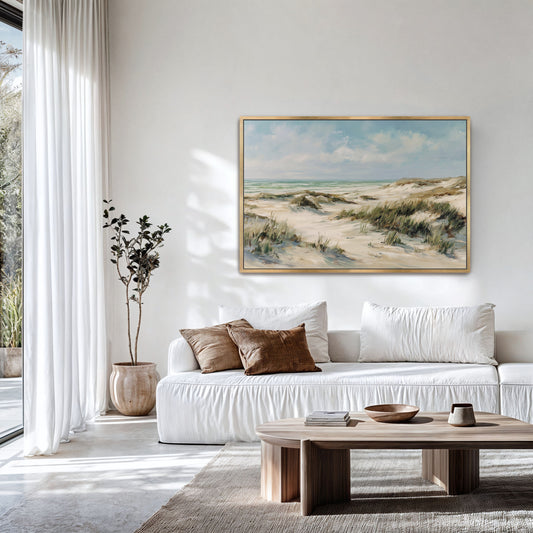 Large coastal dunes framed wall art hanging above a modern sofa