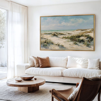 Coastal dunes framed canvas wall art displayed above a modern white sofa