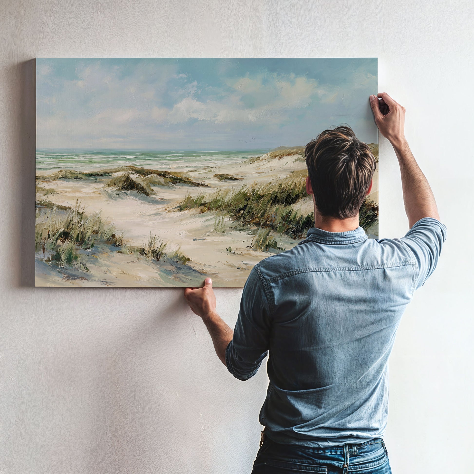 Man hanging coastal dunes unframed canvas art on wall