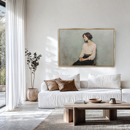 Oversized contemplative portrait in a gold frame above a modern white sofa with earthy decor.