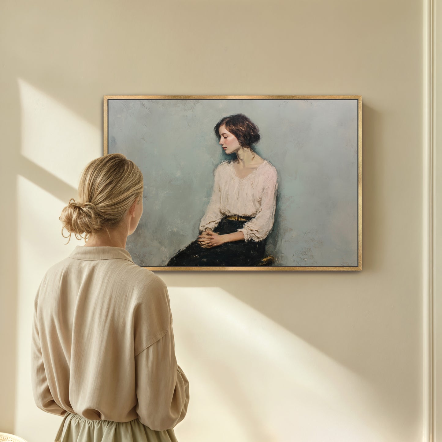 Woman standing in front of framed contemplative portrait, sunlight casting across a beige wall.