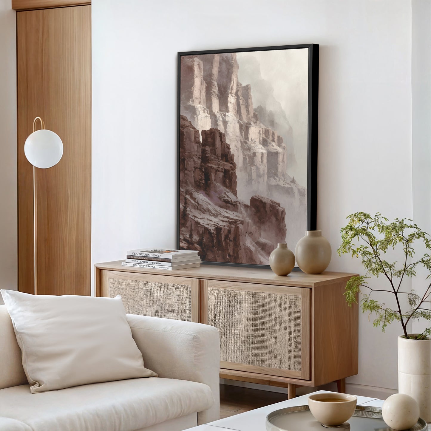 Modern living room with canyon cliff wall art in a black frame above console table