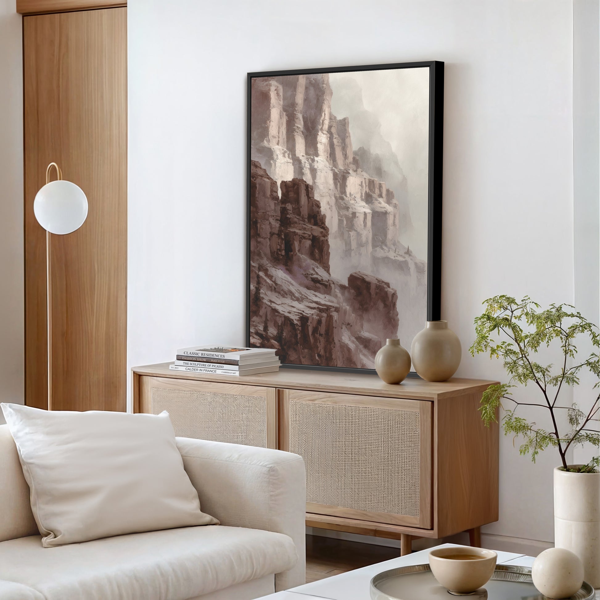Modern living room with canyon cliff wall art in a black frame above console table