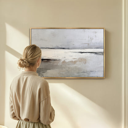 A woman stands in front of a large painting, gazing at it with interest.
