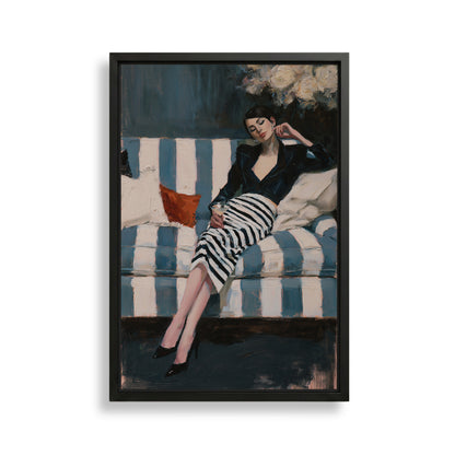 A woman in a black and white striped dress is sitting on a blue and white striped couch, with a red pillow on the couch.