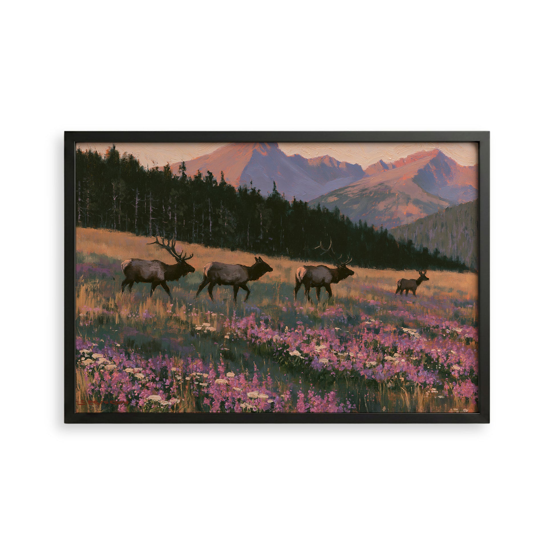 A framed painting depicting a group of elk walking through a field of wildflowers, with mountains in the background.