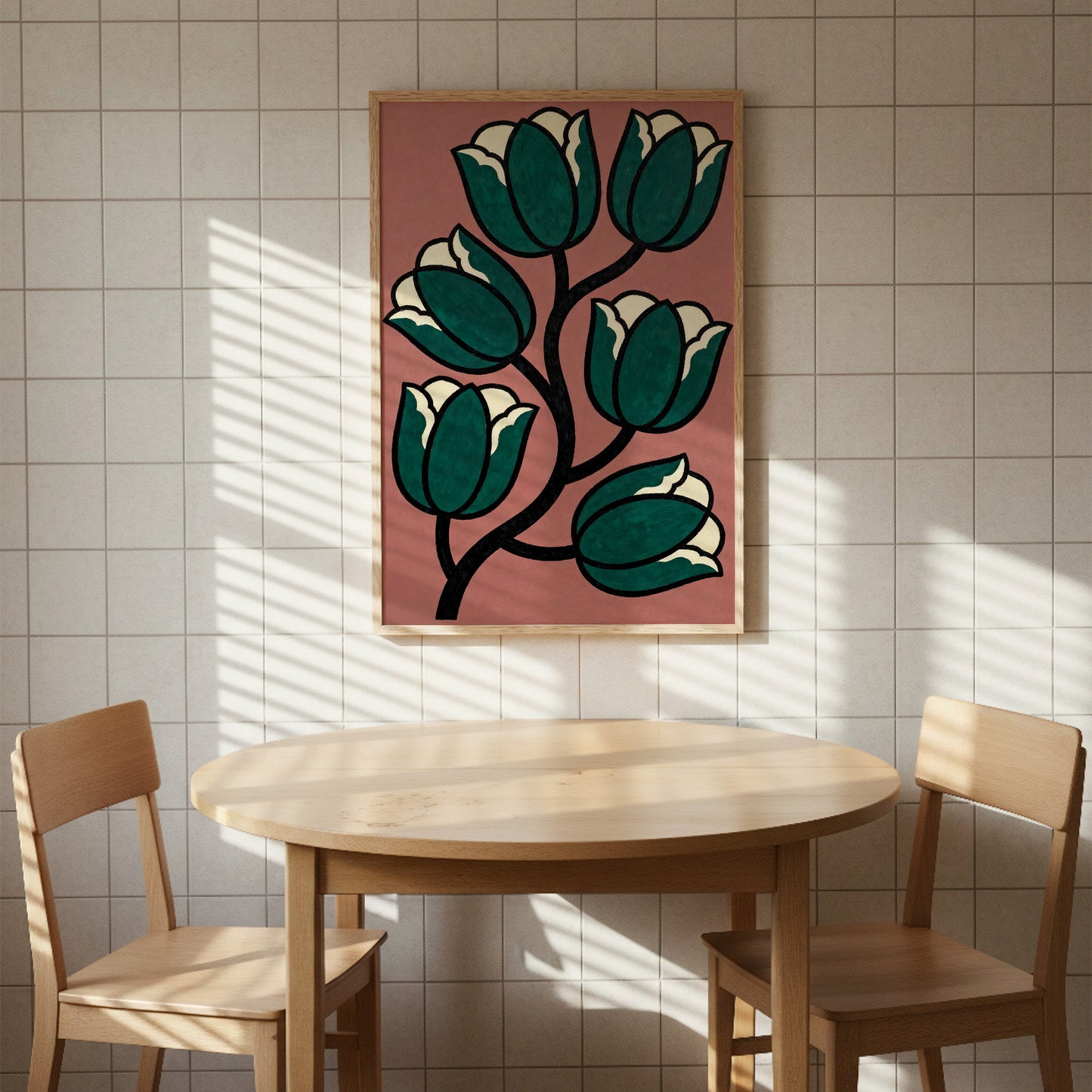a wooden table with two chairs, and a framed artwork of green tulips hanging on the wall above the table.