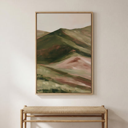 a large painting of a mountainous landscape hanging on a wall above a wooden bench.