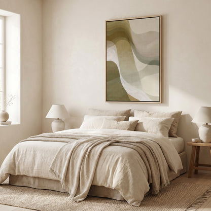 a serene and cozy bedroom with a large bed, a wooden nightstand, and a framed abstract artwork on the wall.