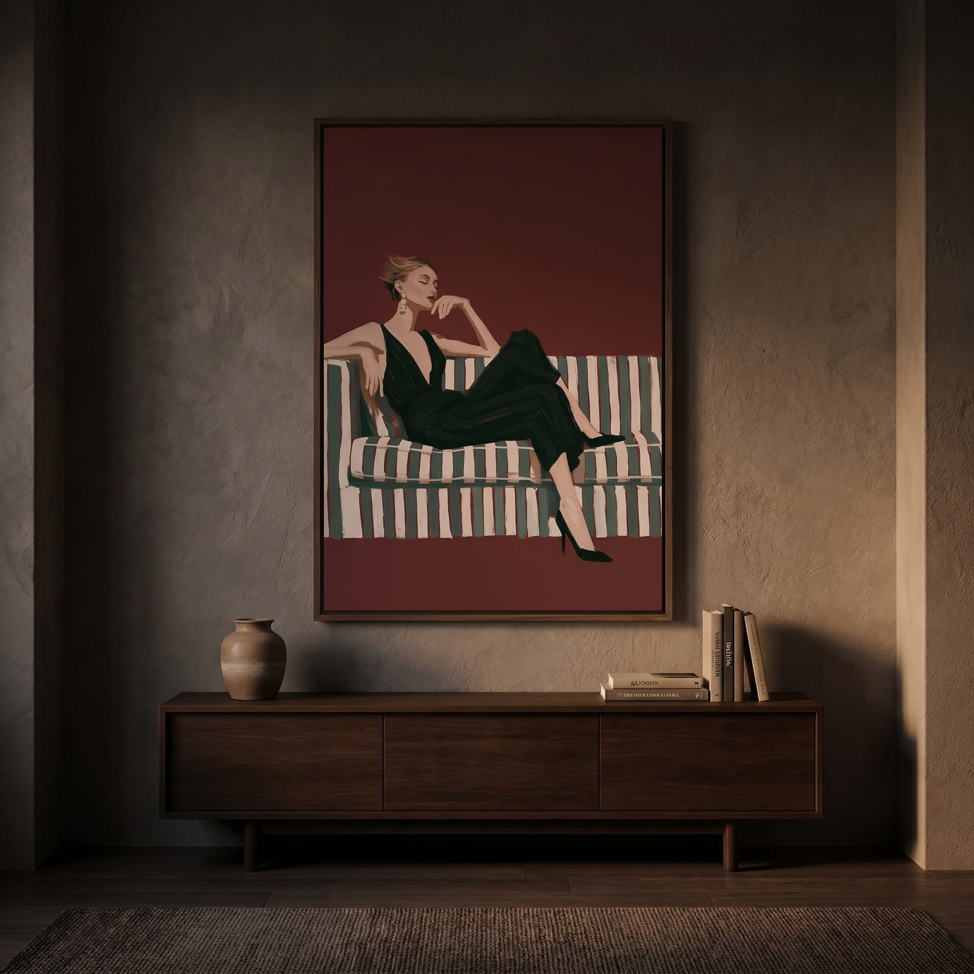 a woman sitting on a striped couch, with a wooden cabinet below the painting and a vase on the cabinet.