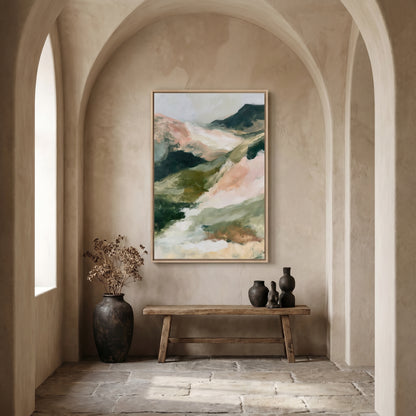a large painting of a mountain landscape hanging on a wall, with a wooden bench and two vases placed in front of it. The room has arched doorways and a stone floor, creating a cozy and inviting atmosphere.