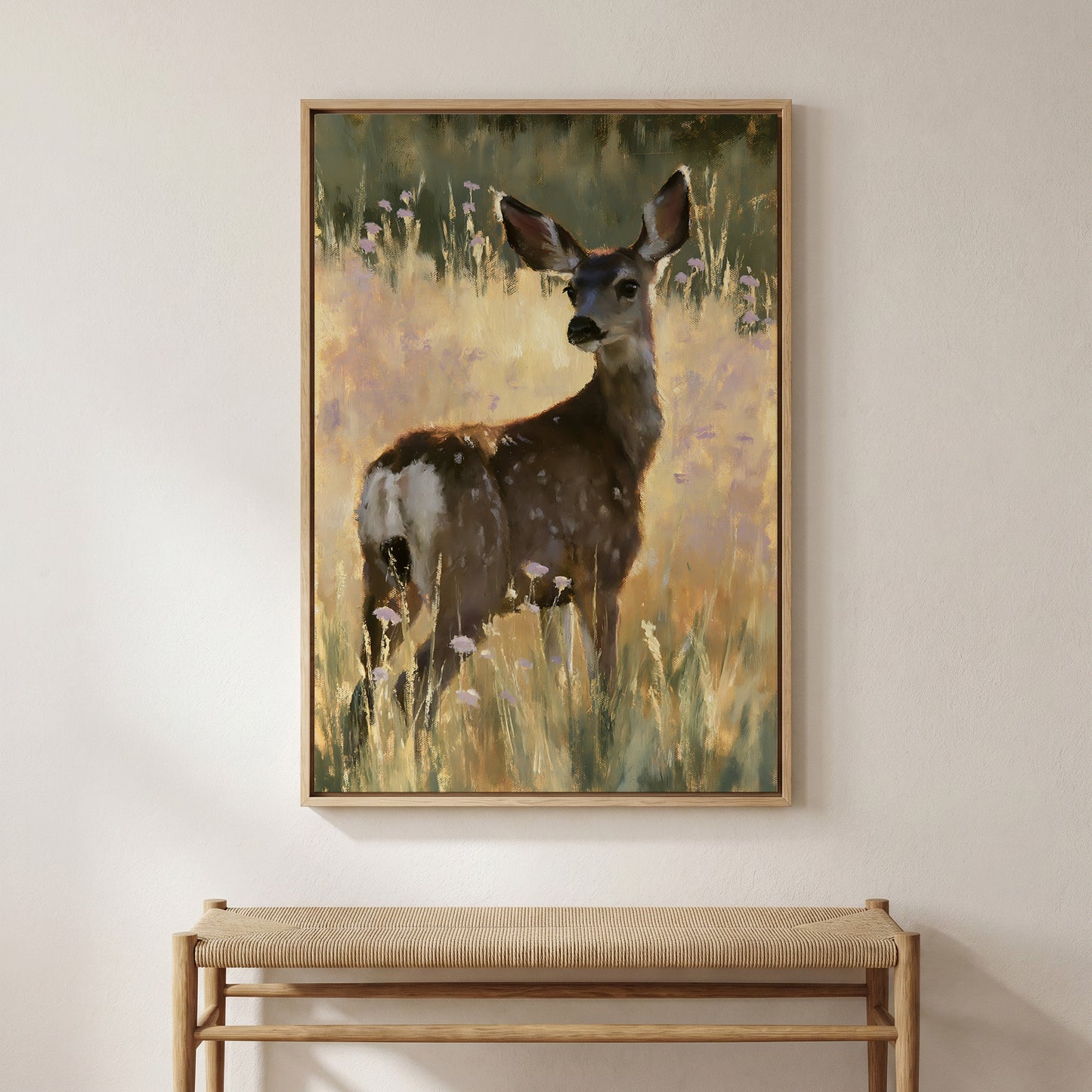 a deer standing in a field of tall grass and wildflowers.