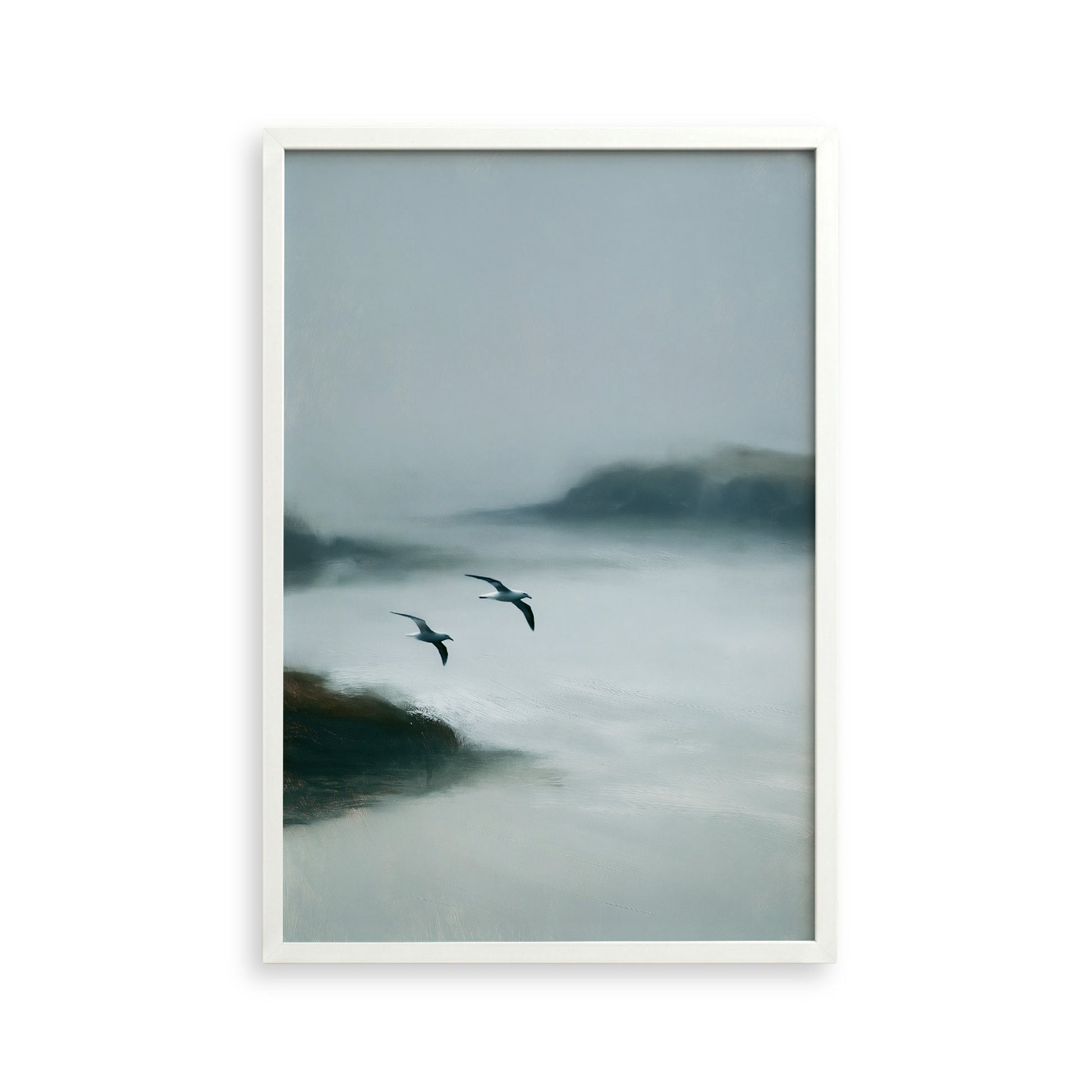 Two birds flying over a misty, foggy landscape.