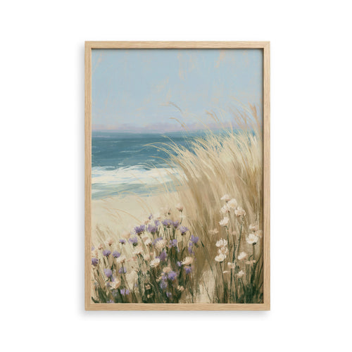 The image is a framed painting depicting a serene coastal scene with a blue sky, ocean, and tall grasses with white flowers.