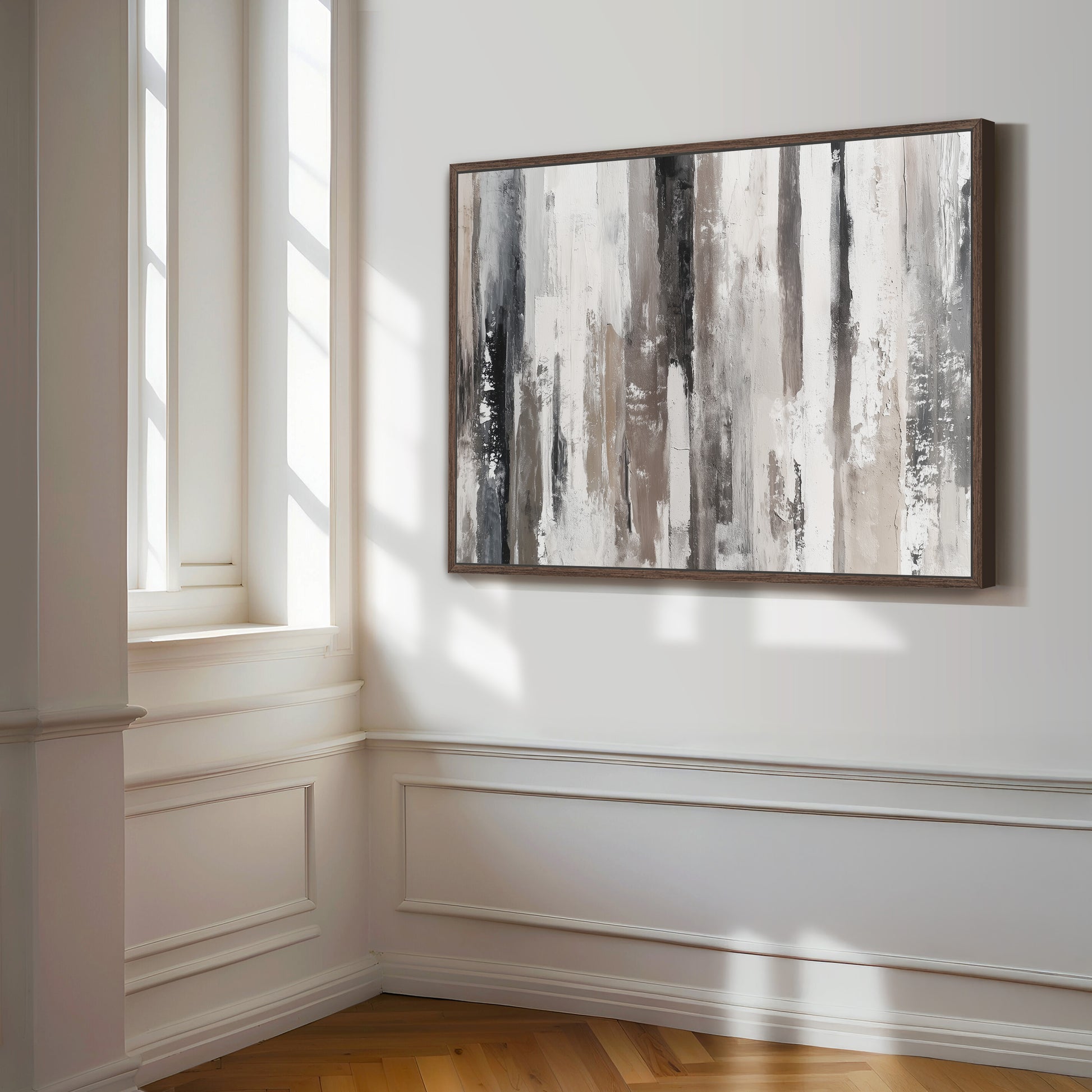 a large abstract painting hanging on a white wall in a room with a wooden floor.