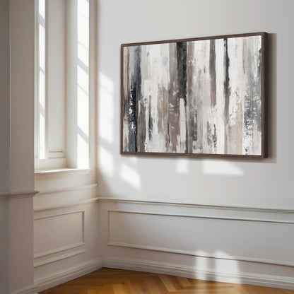 a large abstract painting hanging on a white wall in a room with a wooden floor.