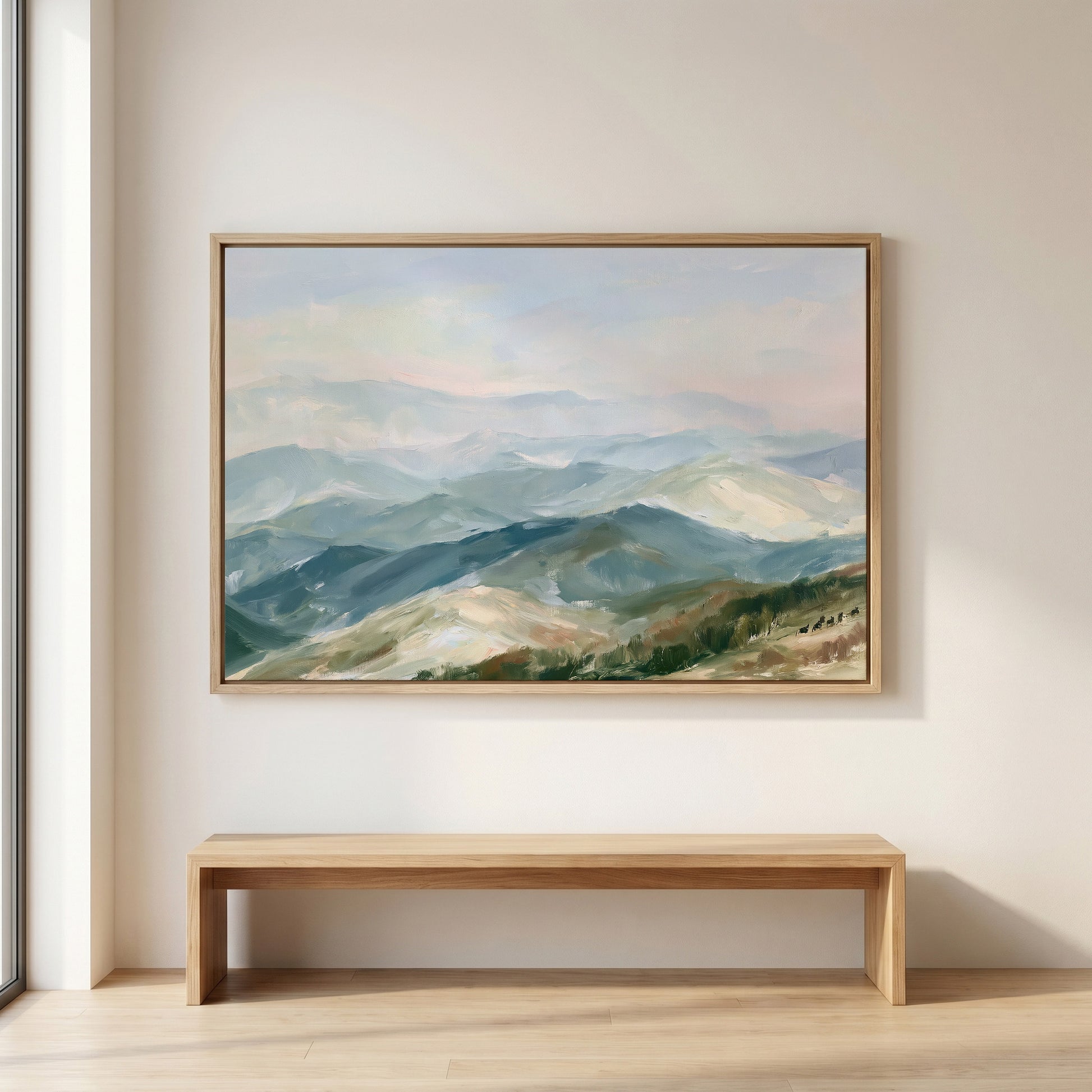 a large painting of a mountainous landscape hanging on a wall above a wooden bench.