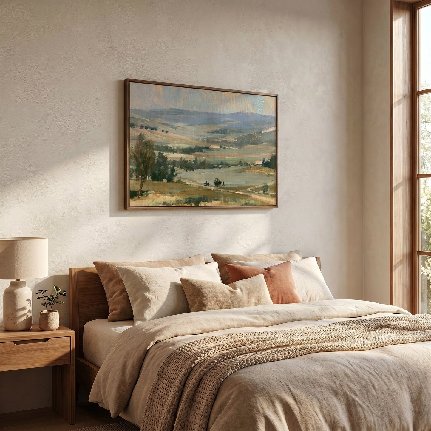 a serene bedroom scene with a large landscape painting hanging on the wall above a bed with a beige comforter and pillows.