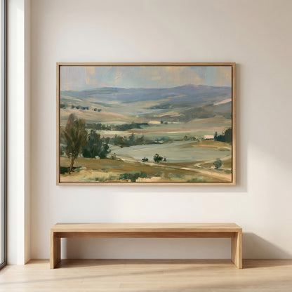 a large landscape painting hanging on a white wall above a wooden bench.