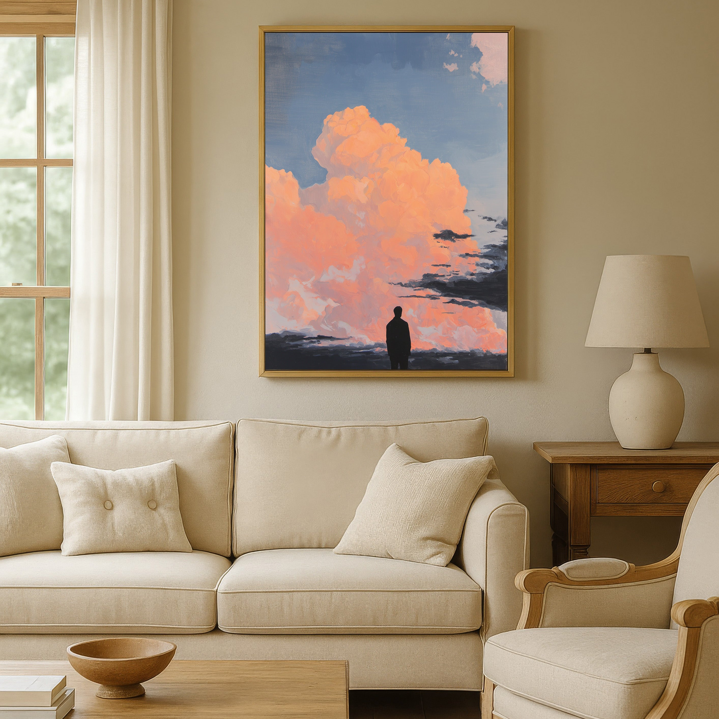 a serene living room with a large framed painting of a person standing in front of a picturesque sky with clouds. The painting is hung on the wall above a beige sofa and a wooden coffee table. The room also features a window, a lamp, and a chair, creating a cozy and inviting atmosphere.