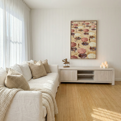 a cozy living room with a white sofa, a wooden coffee table, and a framed beach scene painting on the wall.