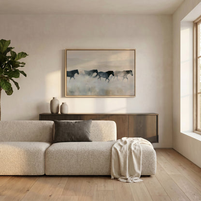 a serene living room with a large window, a white sofa, a wooden cabinet, and a framed painting of horses in motion.