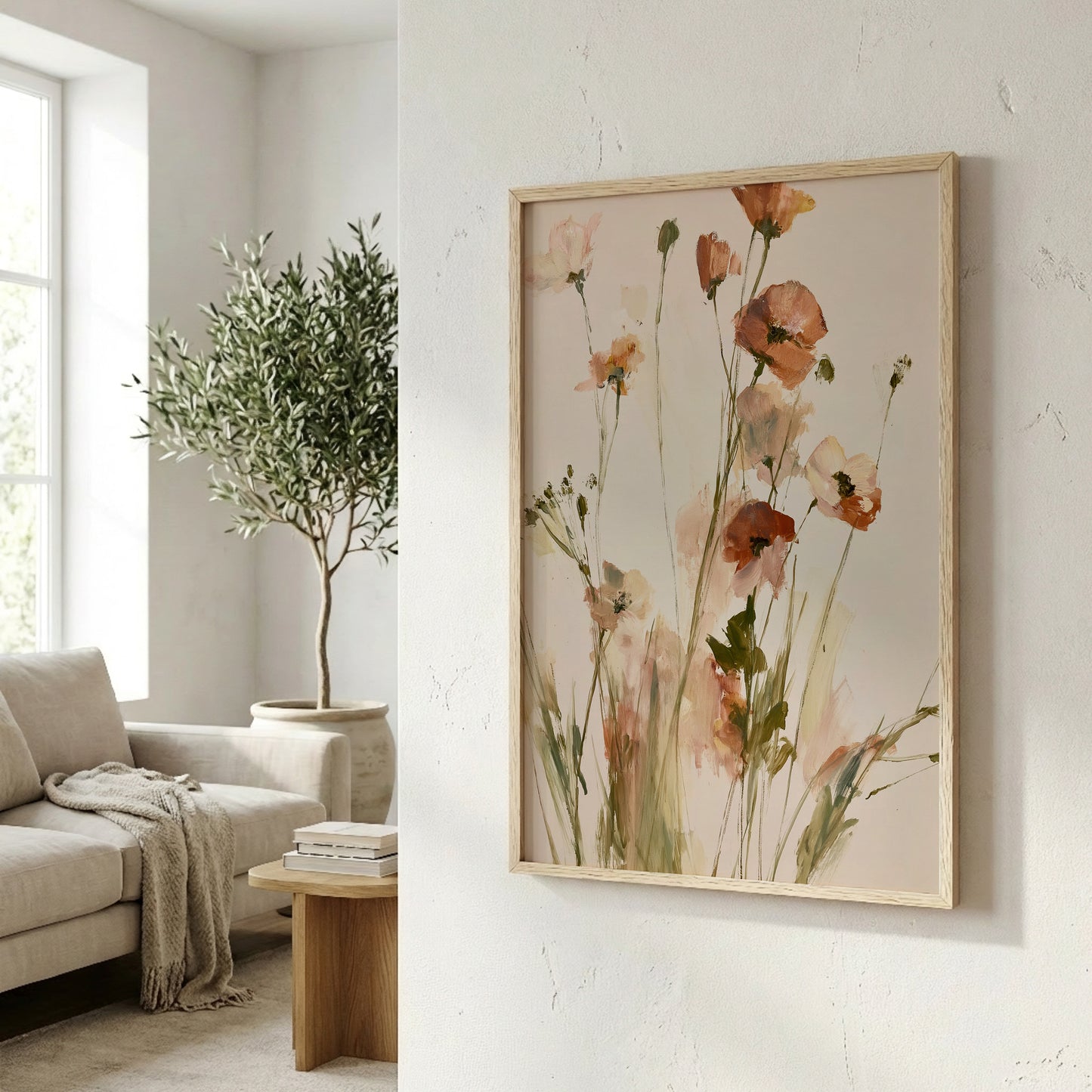 a living room with a large framed painting of flowers hanging on the wall, a sofa, a wooden coffee table, and a potted plant.