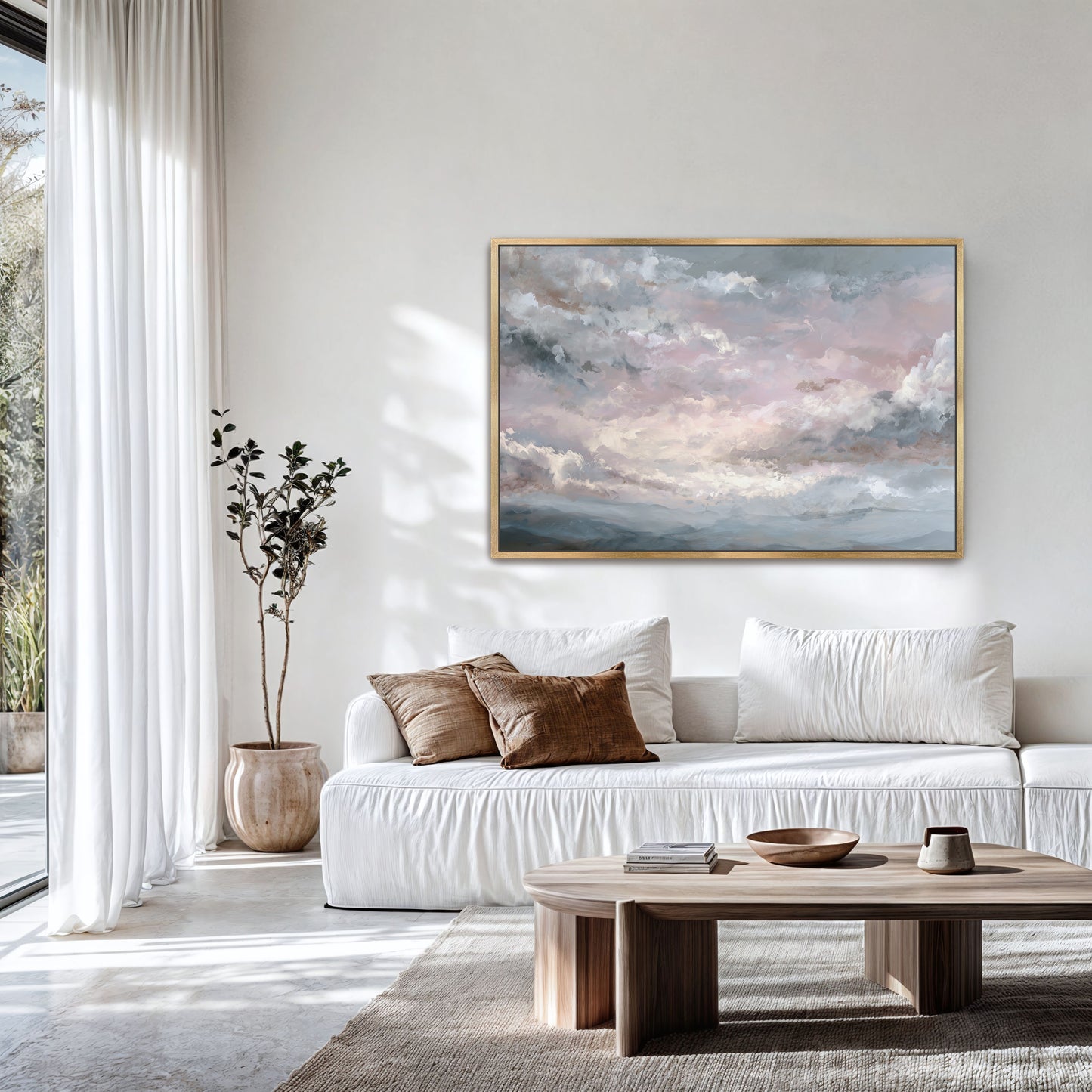 Modern living room with large pink sky artwork in a gold frame.