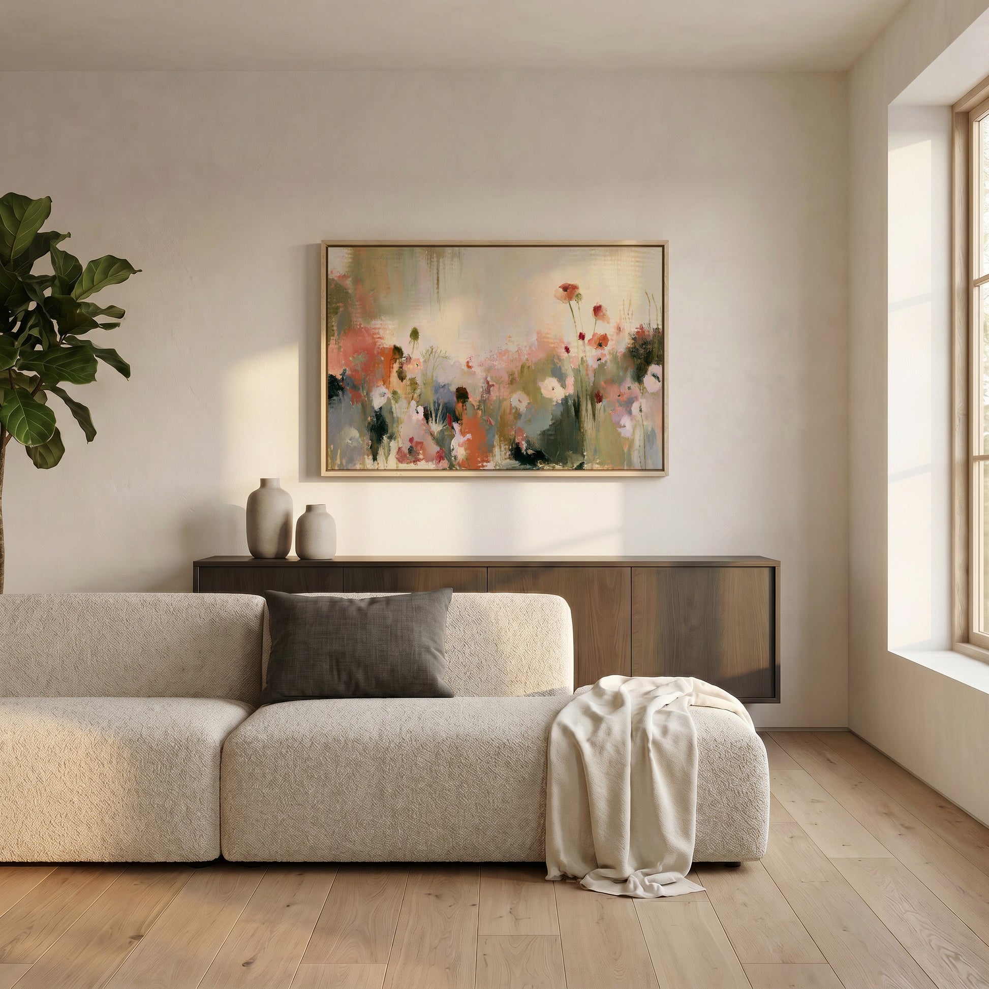 a modern living room with a large, colorful painting of flowers hanging on the wall above a beige sofa. The sofa is positioned in front of a wooden cabinet, and there is a large window allowing natural light to fill the space.