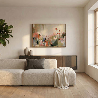 a modern living room with a large, colorful painting of flowers hanging on the wall above a beige sofa. The sofa is positioned in front of a wooden cabinet, and there is a large window allowing natural light to fill the space.
