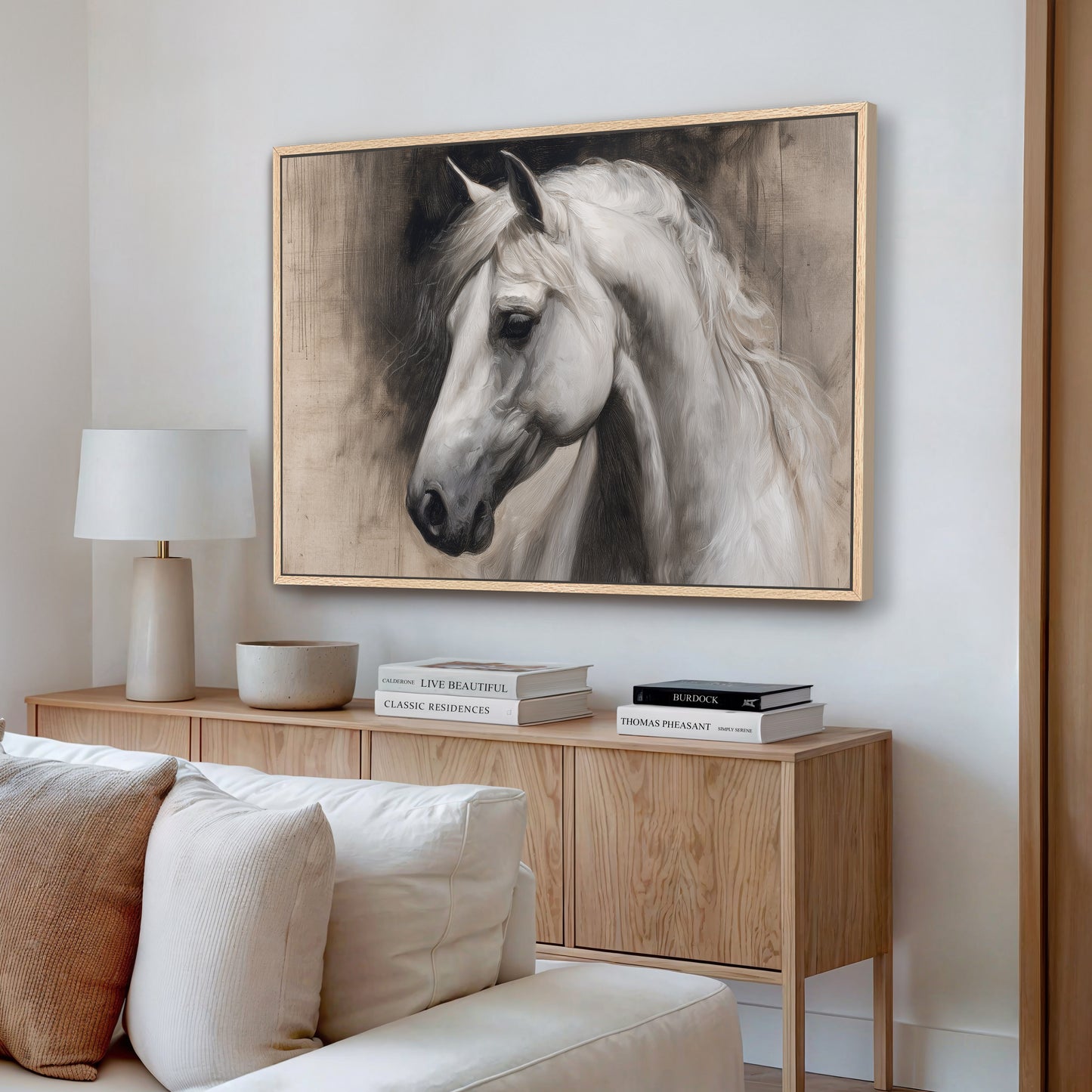 a large framed painting of a white horse on a wall in a living room setting.