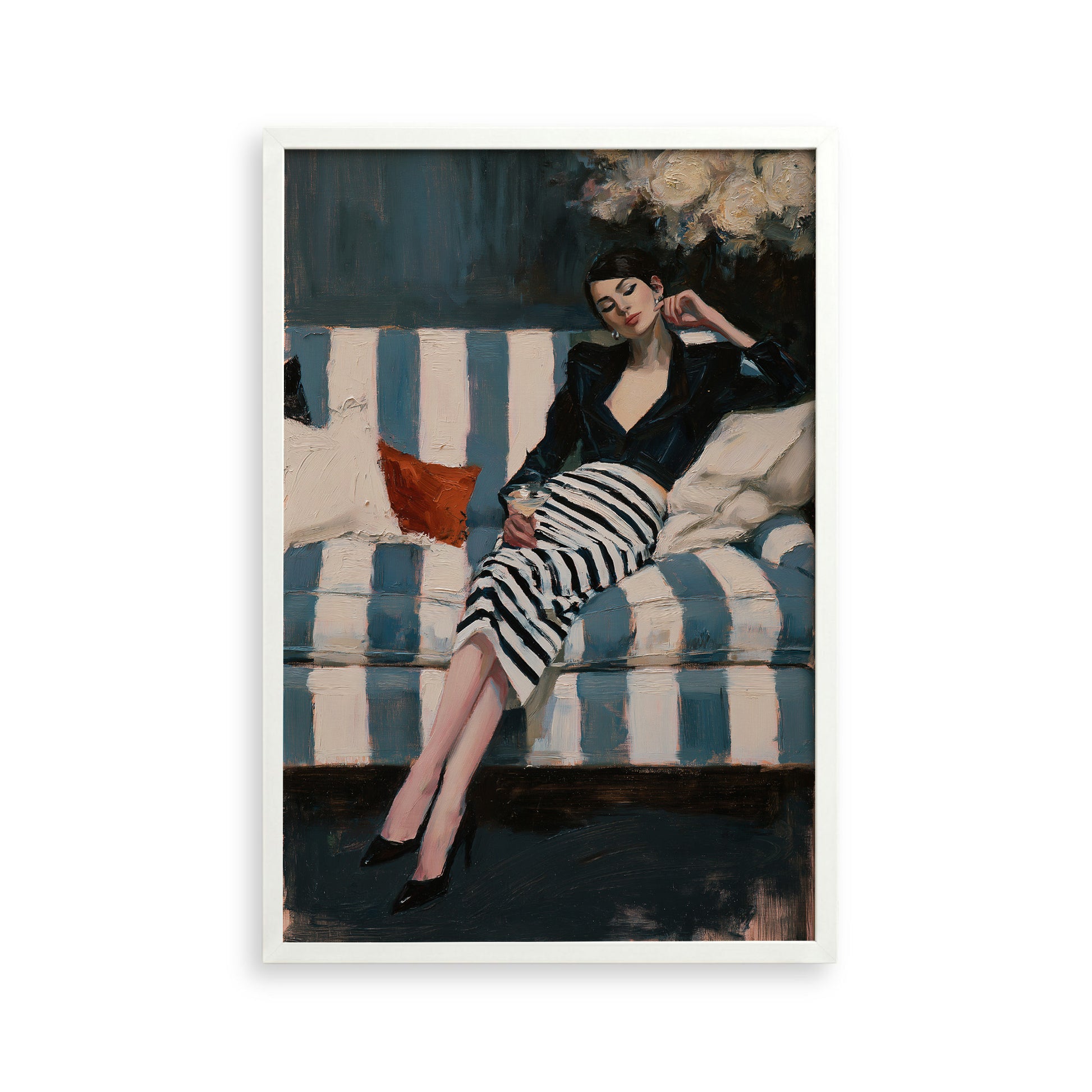A woman in a black and white striped dress is sitting on a striped couch, with a red pillow on the couch.