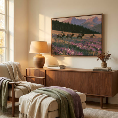 a cozy living room with a large painting of a serene landscape featuring a field of flowers and mountains in the background. The room is furnished with a wooden sideboard, a lamp, and a comfortable chair. A large window allows natural light to fill the space, creating a warm and inviting atmosphere.