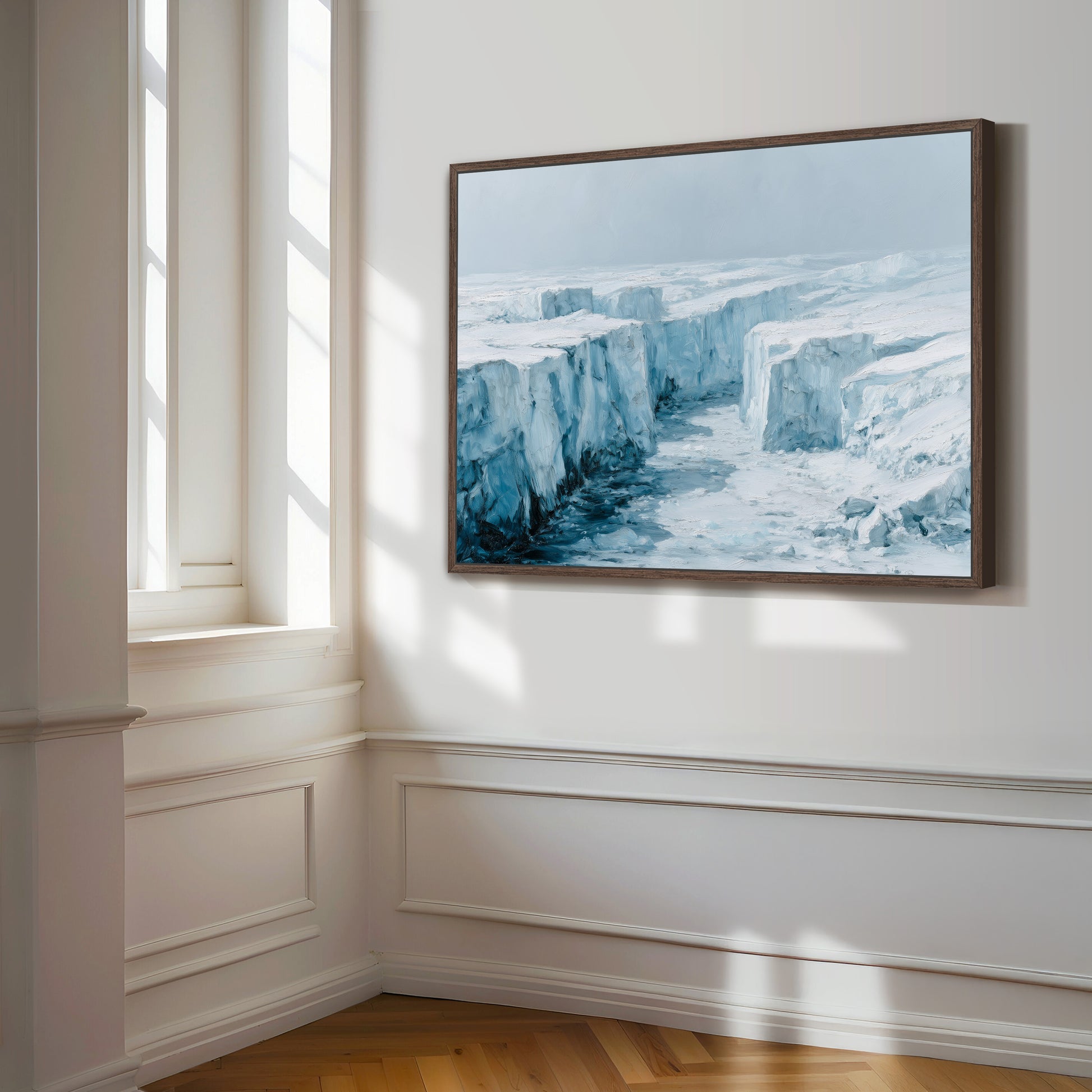 a large, framed painting of a snowy, icy landscape hanging on a white wall.