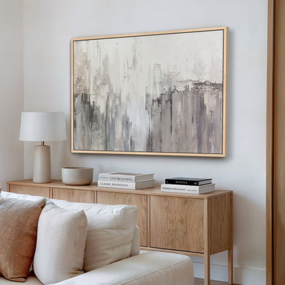 Neutral abstract canvas wall art styled in a modern living room above light wood sideboard