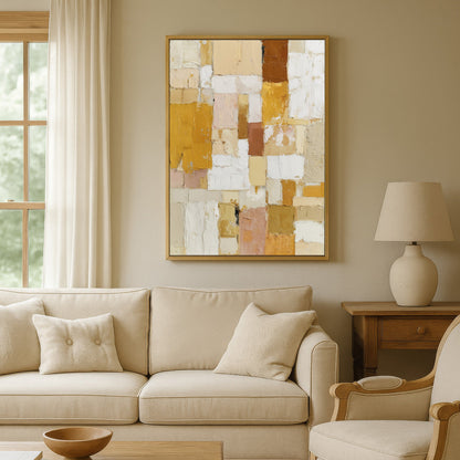 Golden abstract wall art hanging above beige sofa in modern living room.