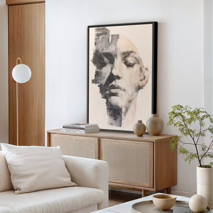 Large abstract portrait painting in black floating frame, styled in a contemporary living room with wood console and modern decor.