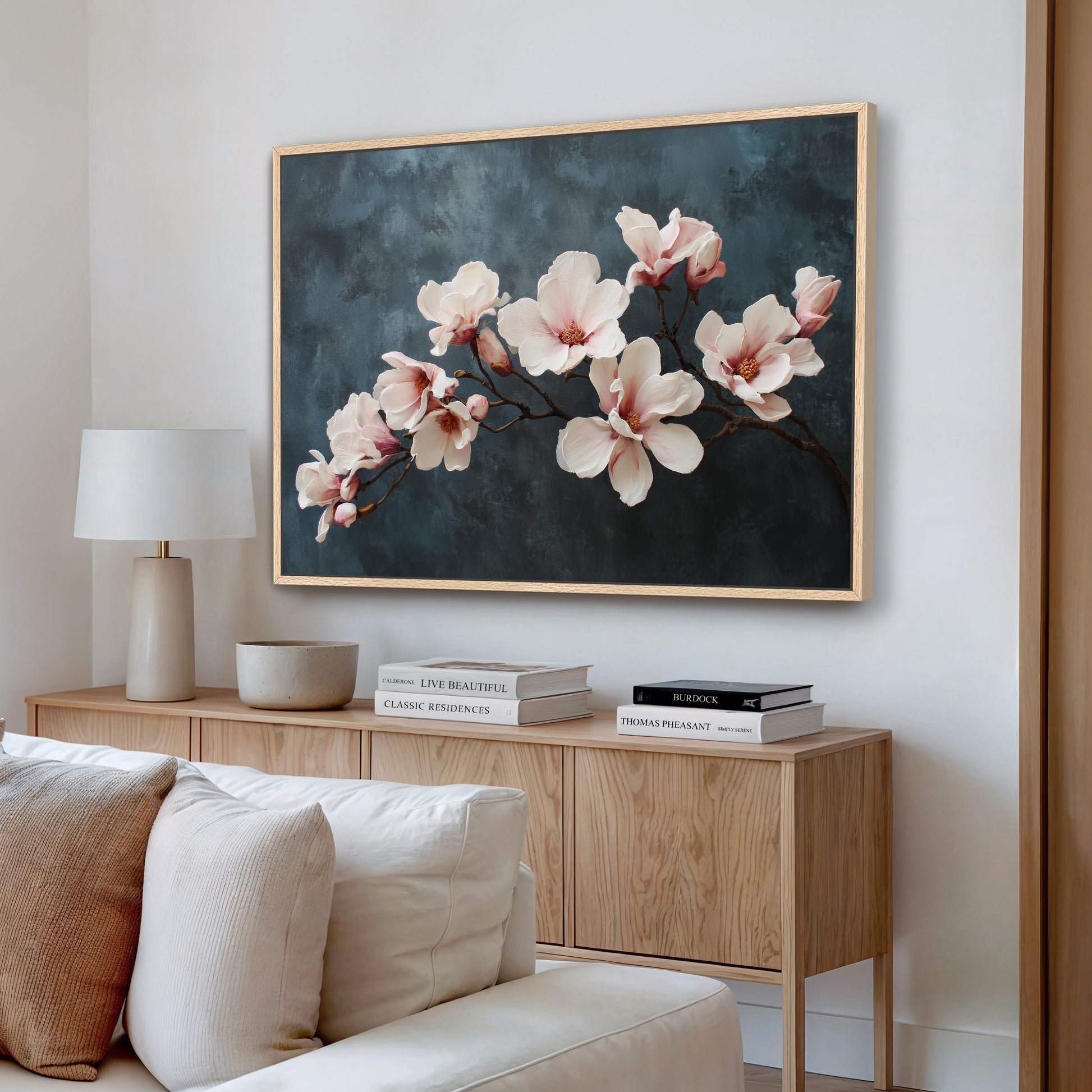Magnolia branch wall art in natural wood frame with ivory and blush flowers.