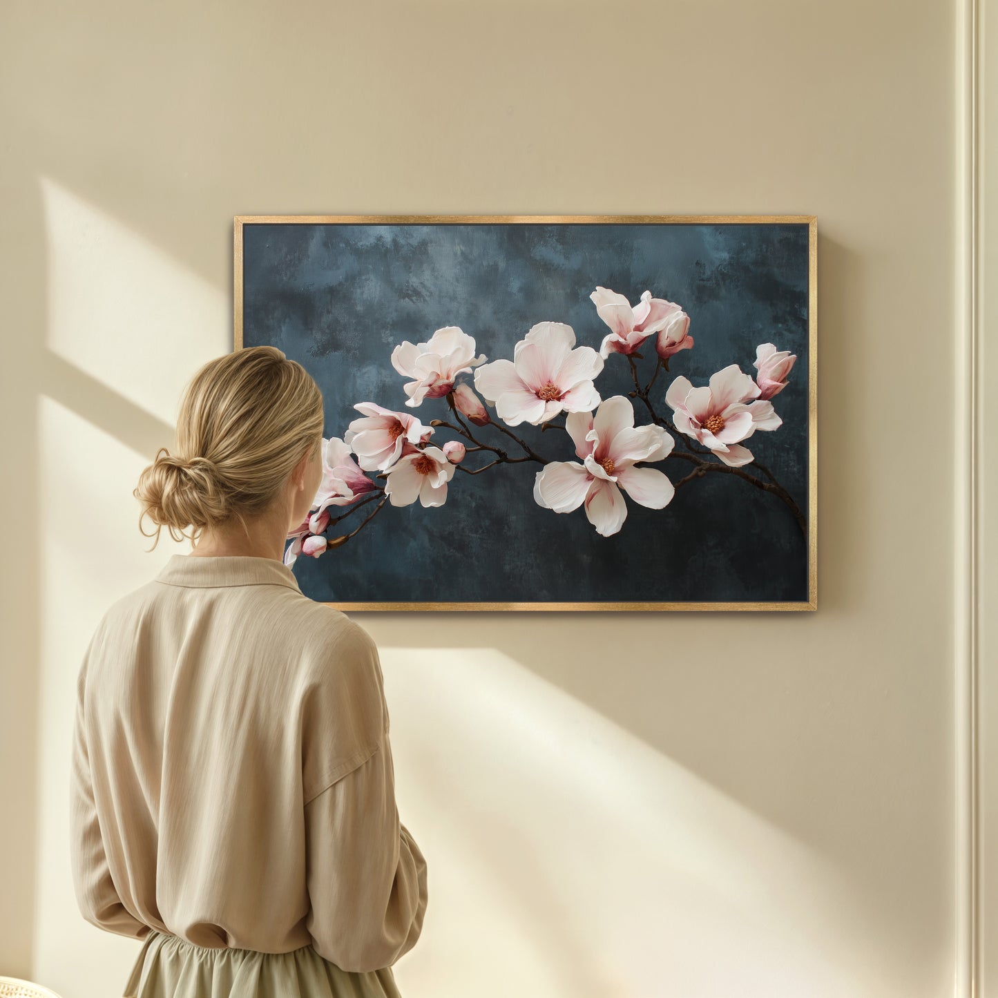 Woman looking at a floral painting on a wall