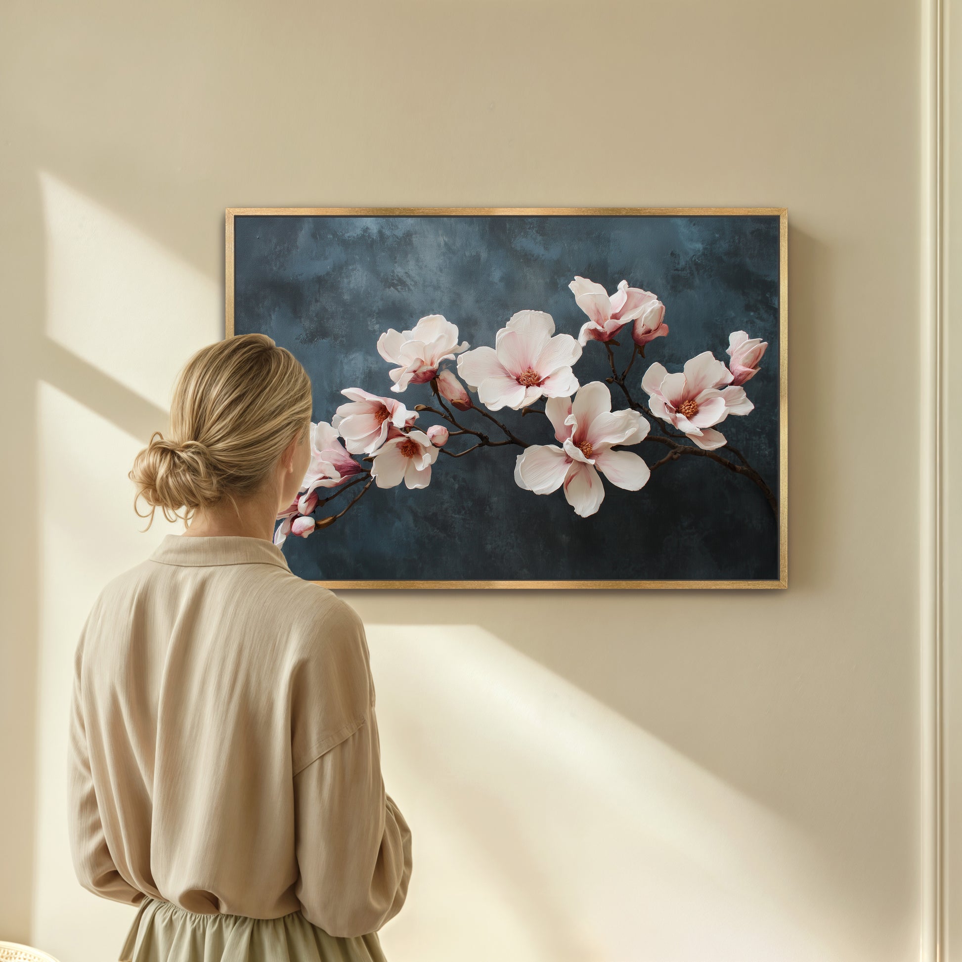 Woman looking at a floral painting on a wall