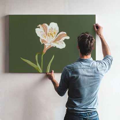 Man hanging large white lily botanical canvas wall art with sage green background