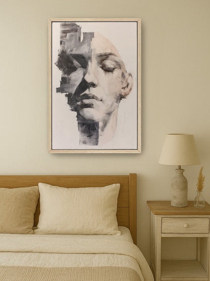 Neutral abstract face portrait in wood frame, hanging above a cozy beige bed in minimalist bedroom decor.