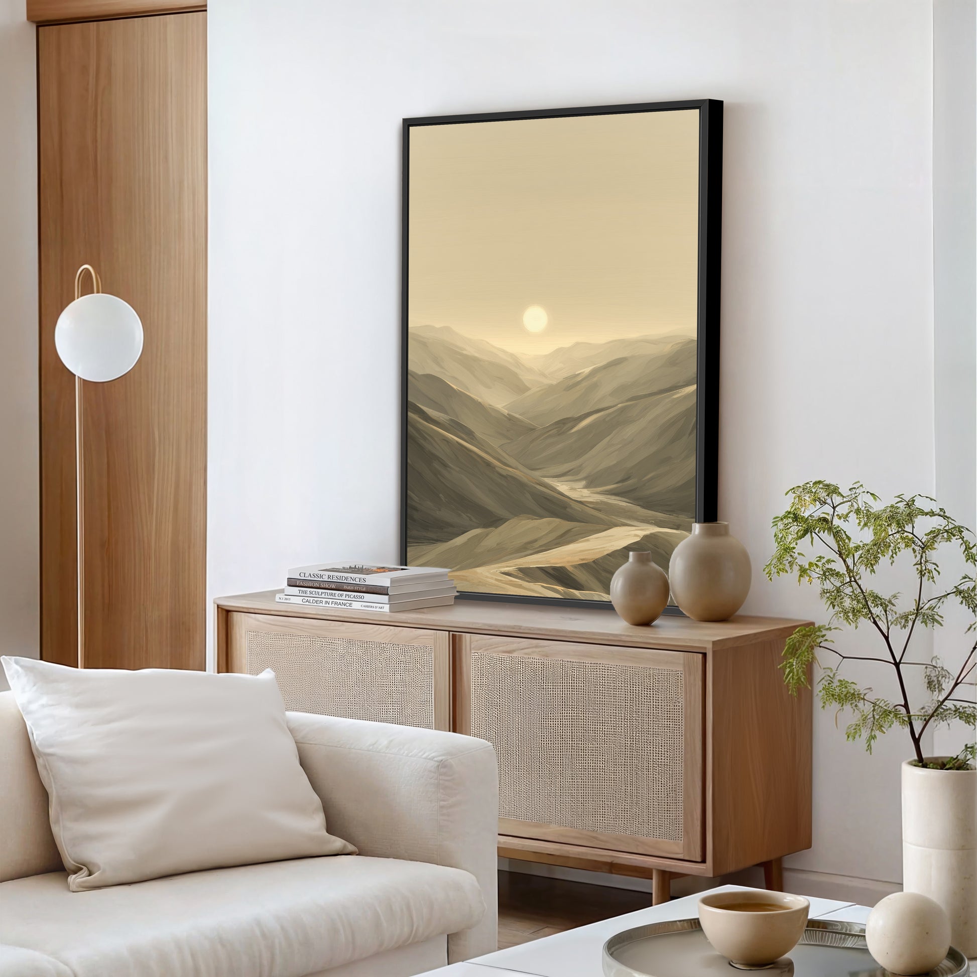 A modern living room console with a black framed canvas sitting on top.