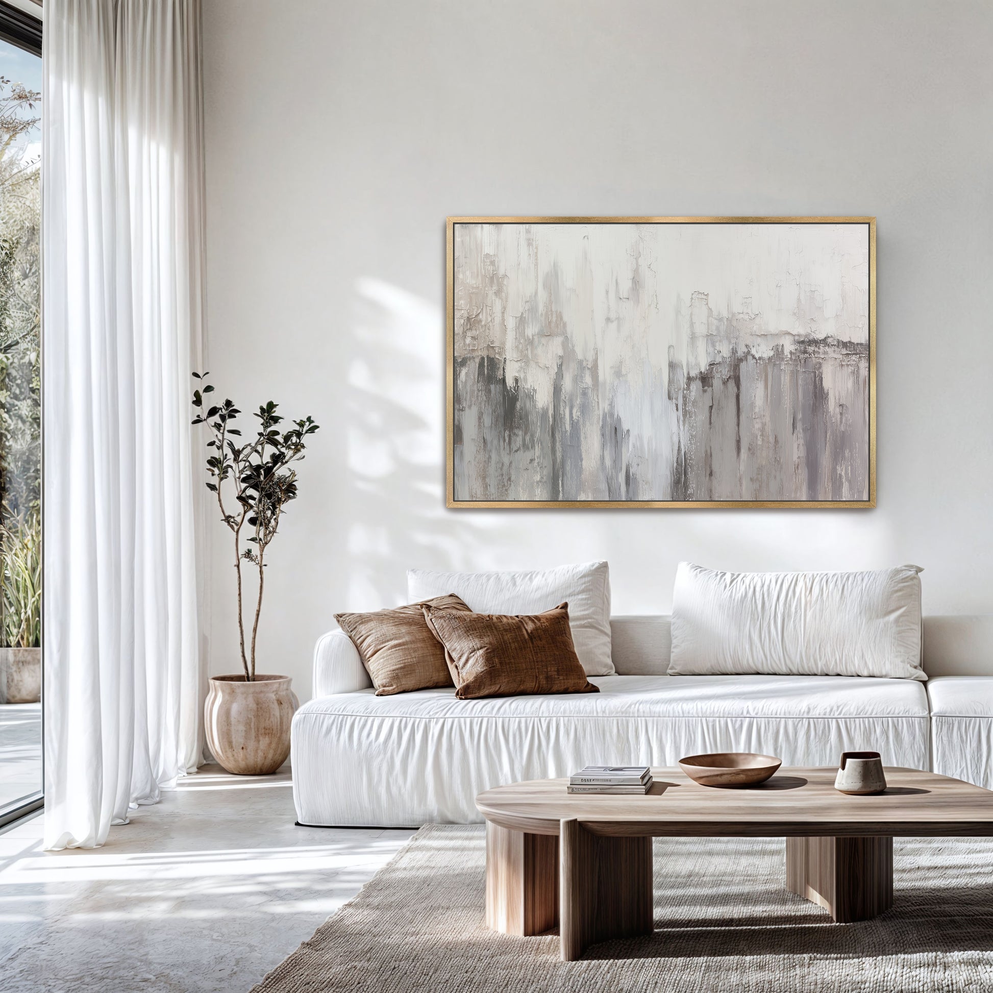 Neutral abstract wall art above sofa with bright natural light