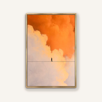 Elegant gold framed canvas print of a lone person balancing on a line surrounded by orange and soft cream clouds.