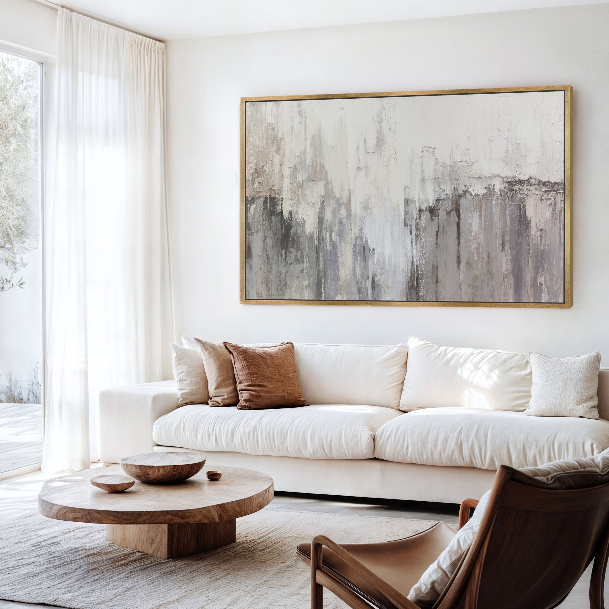 Neutral abstract wall art above a white sofa in modern living room