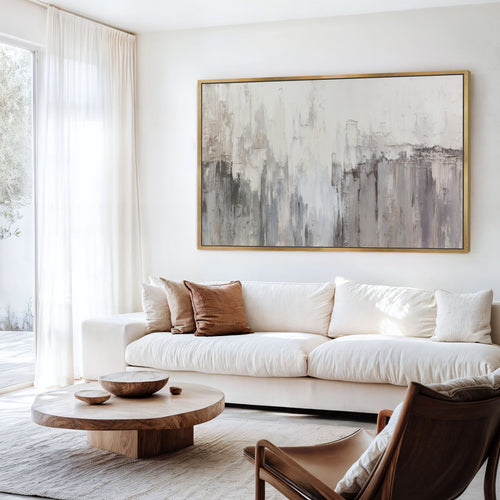 Neutral abstract wall art above a white sofa in modern living room