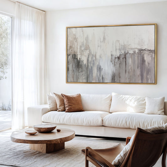 Neutral abstract wall art above a white sofa in modern living room