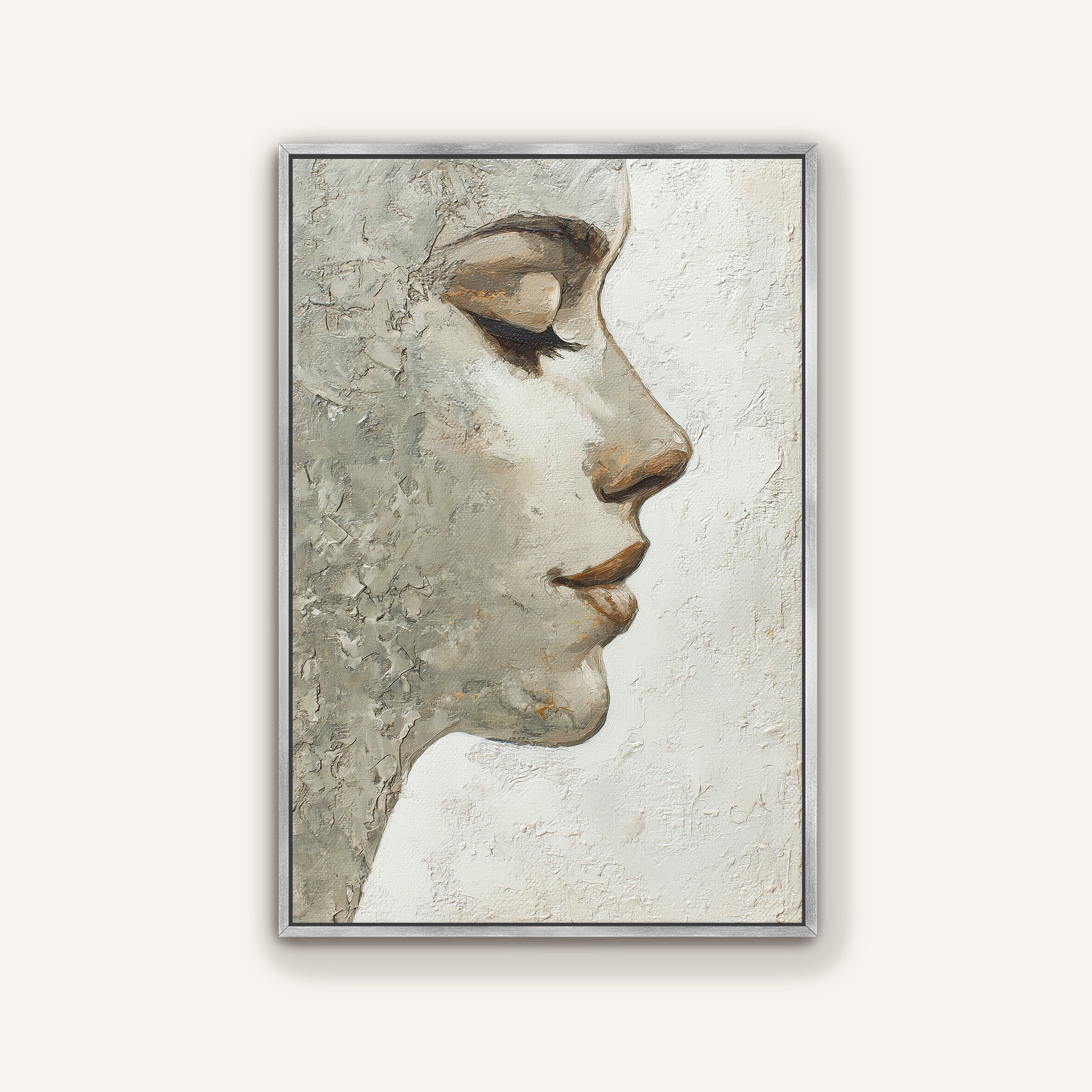 Neutral textured portrait wall art depicting a woman’s face in profile with a sleek silver frame.